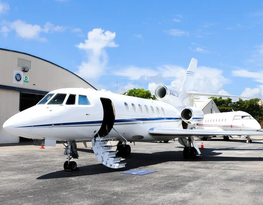 Guests boarding a private jet on the apron