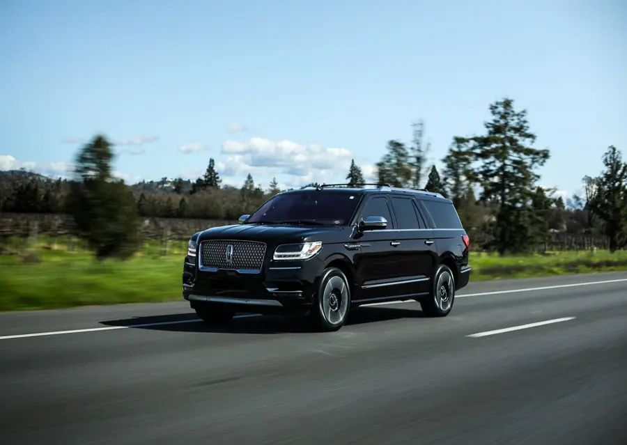 Black SUV on a coastal road